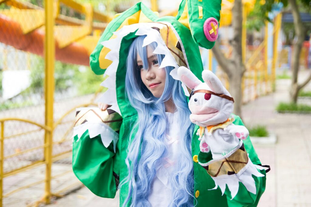 Adult woman in detailed cosplay costume enjoying a festival outdoors with a puppet.