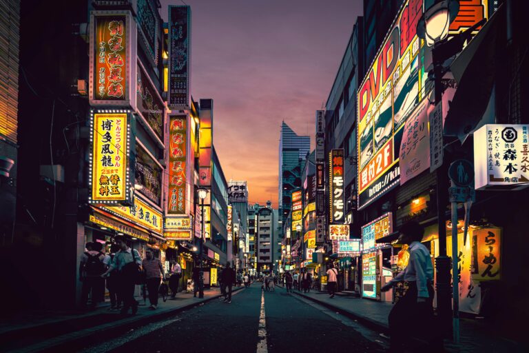 Explore the vibrant nightlife of Shibuya, Tokyo, showcasing neon-lit streets bustling with activity after sunset.
